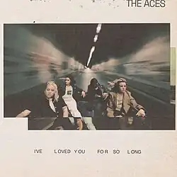 The band seated in the bed of a truck driving in a tunnel with motion blurring in the background