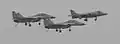 A Sea Harrier flanked by a pair of MiG-29Ks during the retirement of the Sea Harrier.