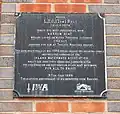 Plaque attached to retaining wall of Tom Rolt Bridge on mooring side of canal