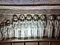 Row of sculpted figures on the north wall