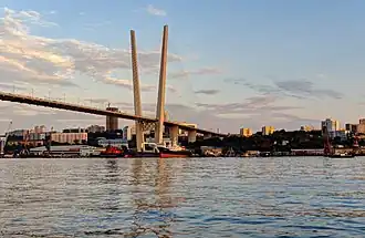 A view of a bridge from the point of view of the body of water below.
