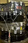 Labeled 100-gallon drums staged for downloading and emplacement in the repository