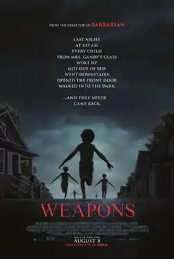 Five children run across a street with houses.