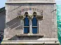 Two-light window in the tower with polychrome brick