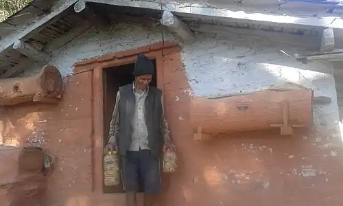 Wooden hives and farmer with packed honey