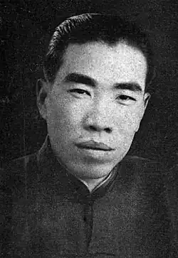 A black-and-white image of a man looking forward