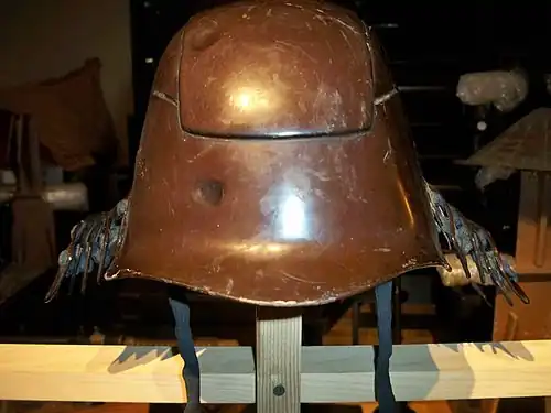 Zunari kabuto with bullet marks from being tested (tameshi).