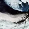 In the top-right corner of the image is Alaska's mainland blanketed with snow, as well as Nunivak Island. At the centre of the image are the islands of Saint Paul and Saint George – part of the Pribilof Islands. Also note the von Kármán vortex street (swirly clouds) in the middle right.